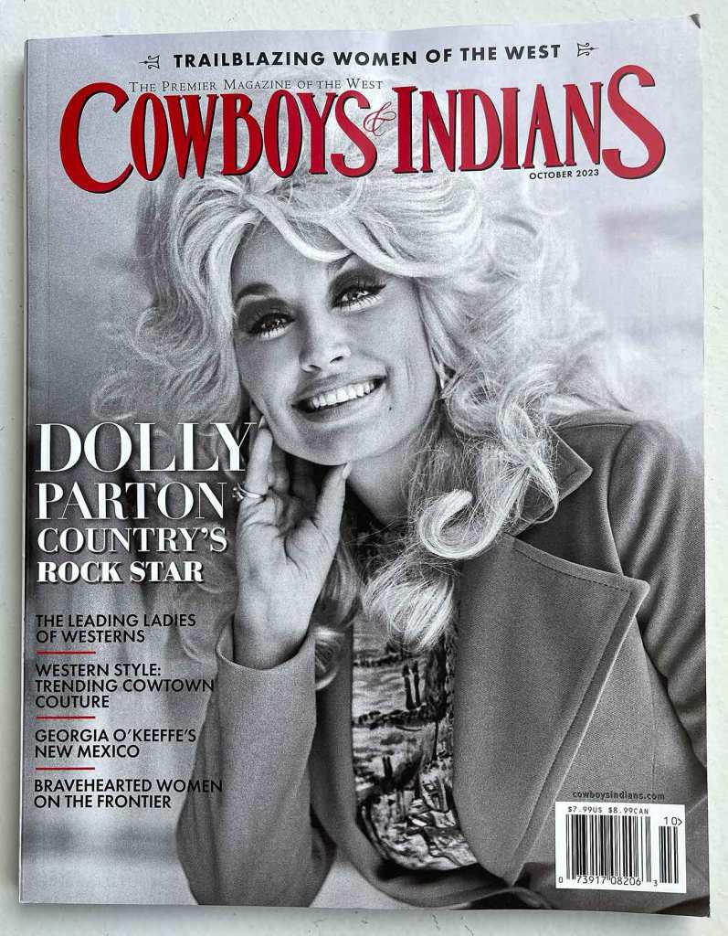Posing and lighting combine in a cover photo of Dolly Parton in the October 2023 issue of Cowboys & Indians magazine to make it look like Parton's right hand is a lobster claw.
