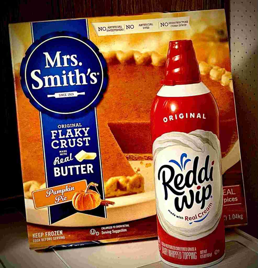 Photo of a box of Mrs. Smith's frozen pumpkin pie and a can of Reddi dip whipped cream.